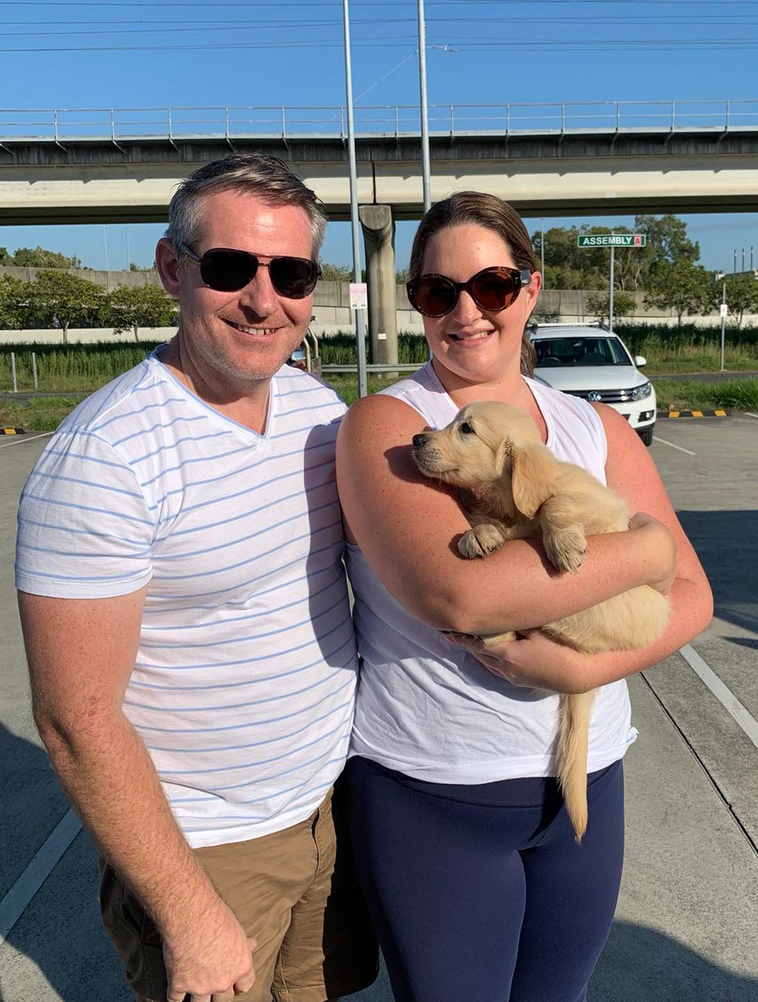 Happy family with their retriever puppy