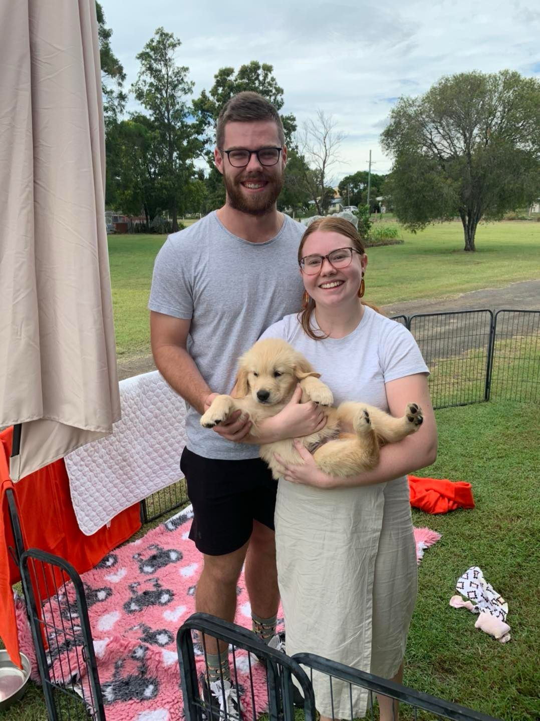 Happy family with their retriever puppy