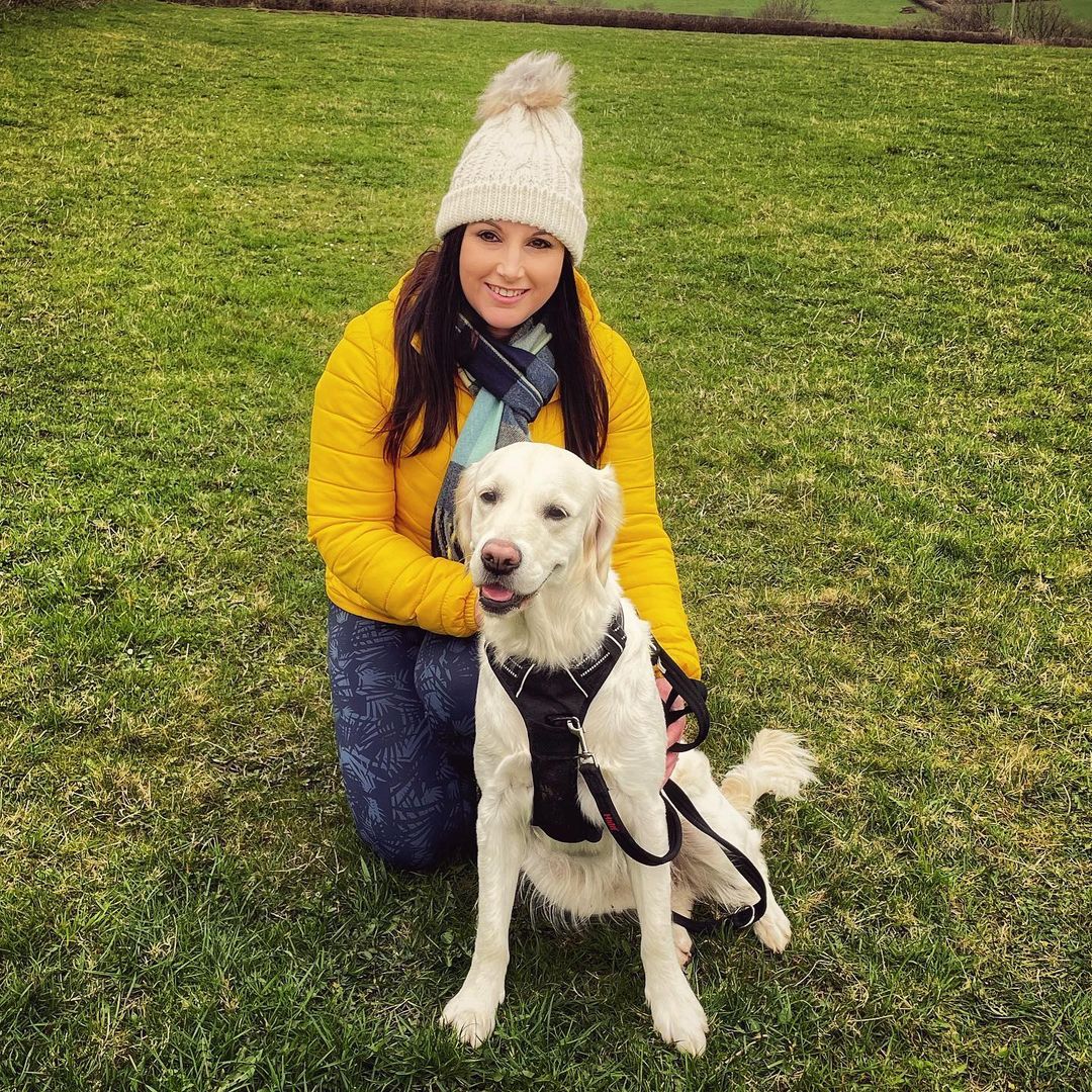 Happy family with their retriever puppy