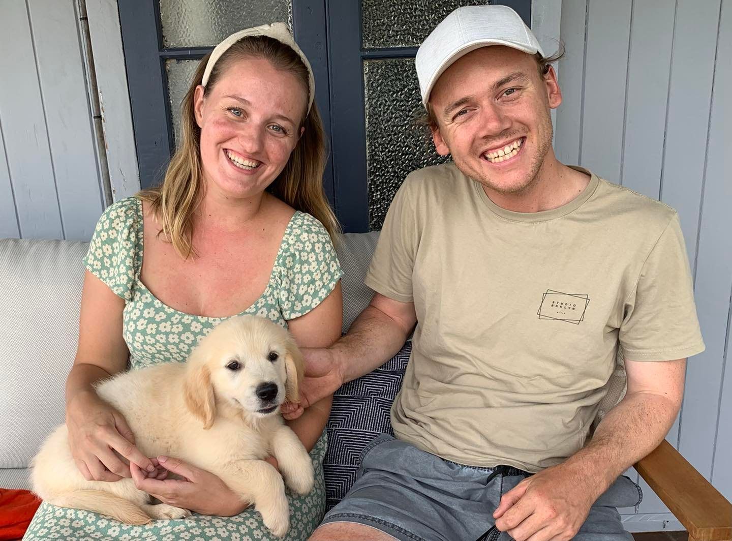 Happy family with their retriever puppy