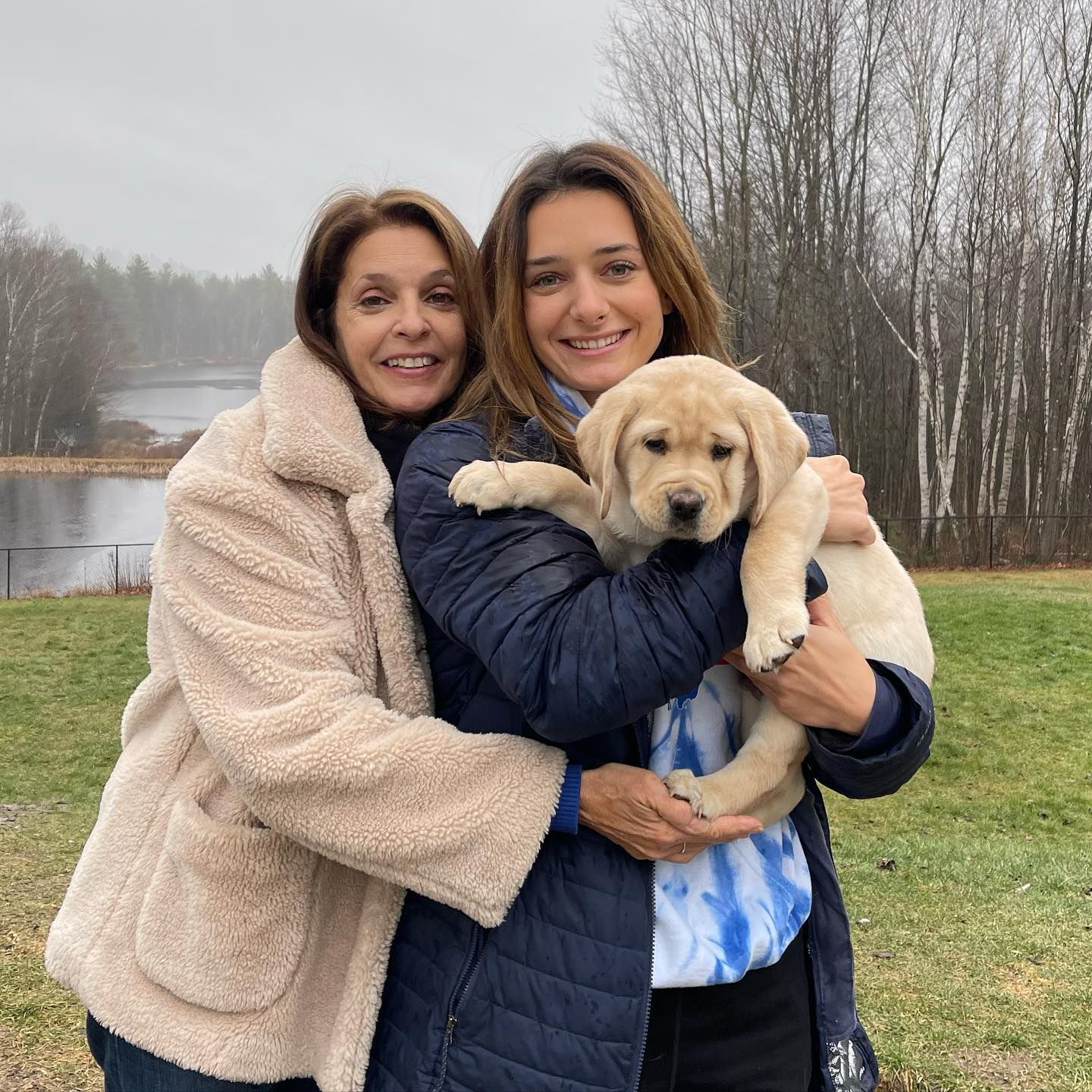 Happy family with their retriever puppy