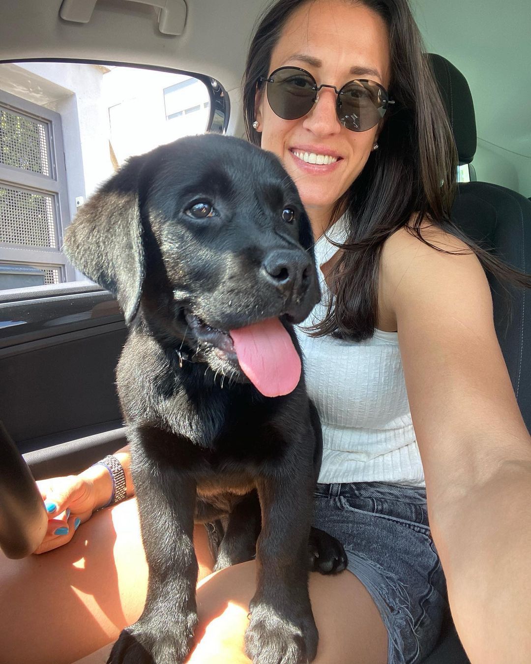 Happy family with their retriever puppy